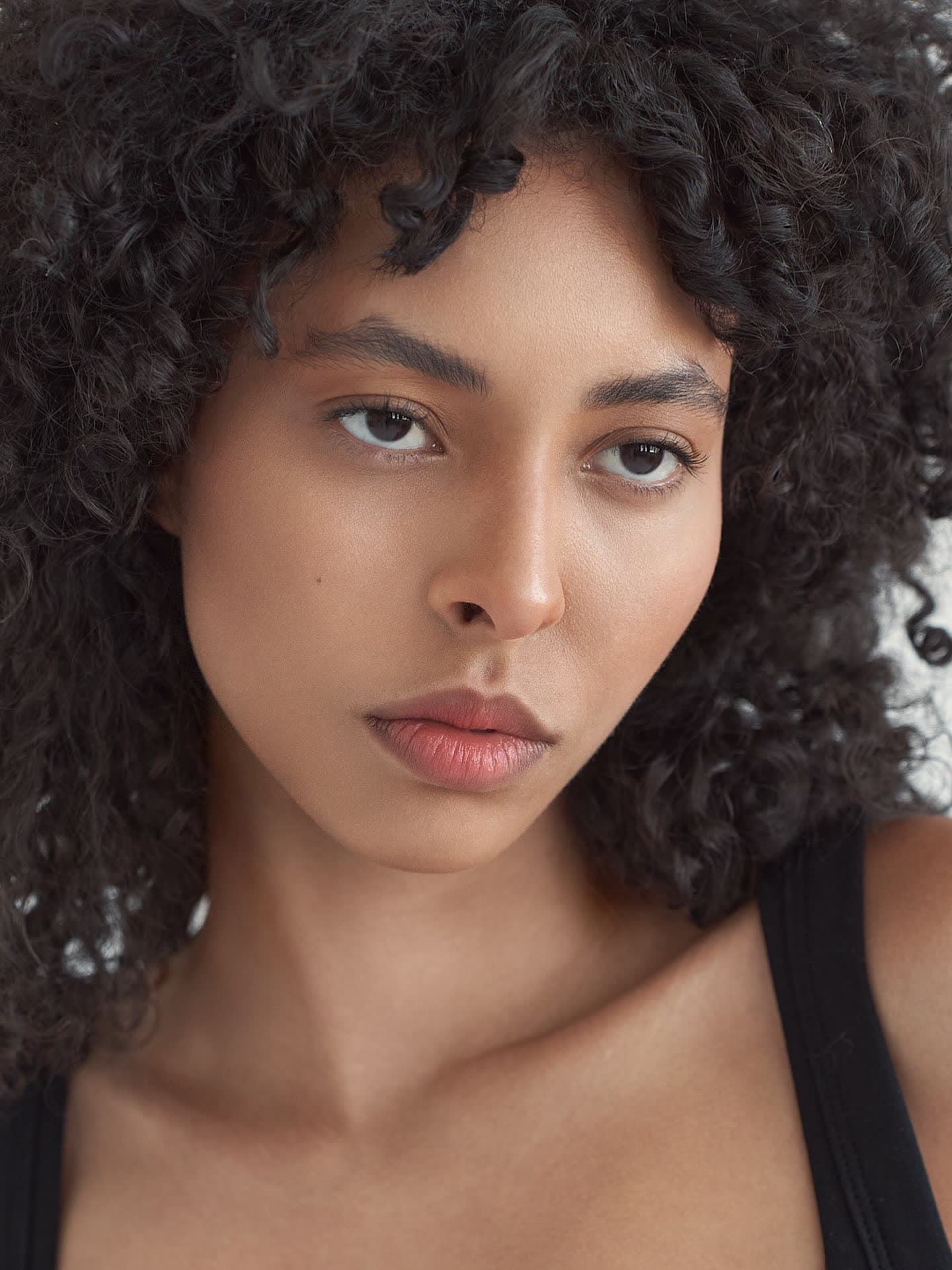 Test frame: natural beauty close-up, bare shoulders and a black tank strap, no retouching
