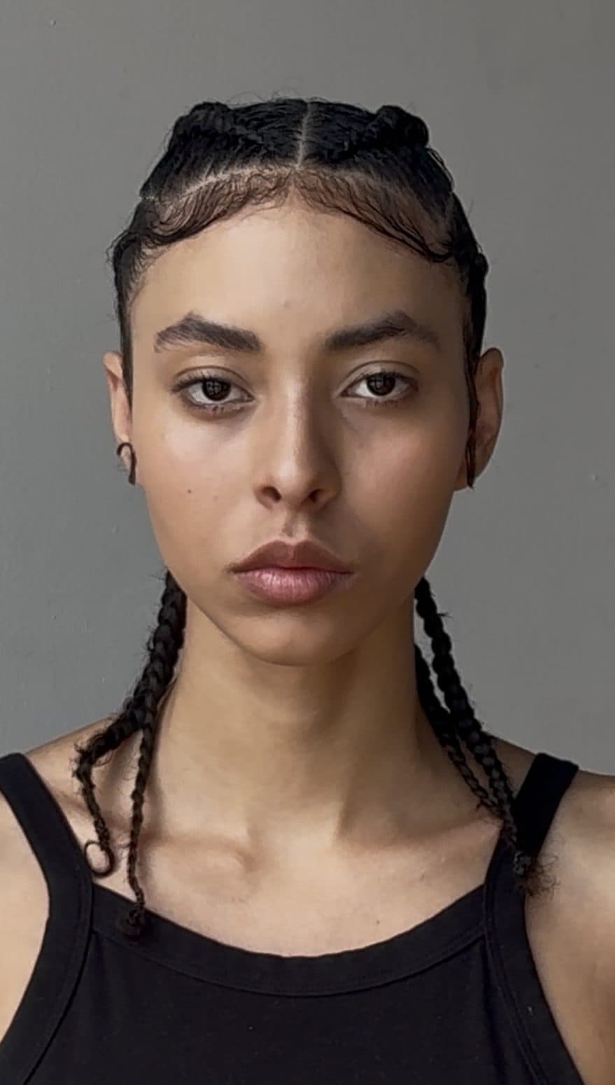 Digital: head shot with cornrow braids, neutral expression