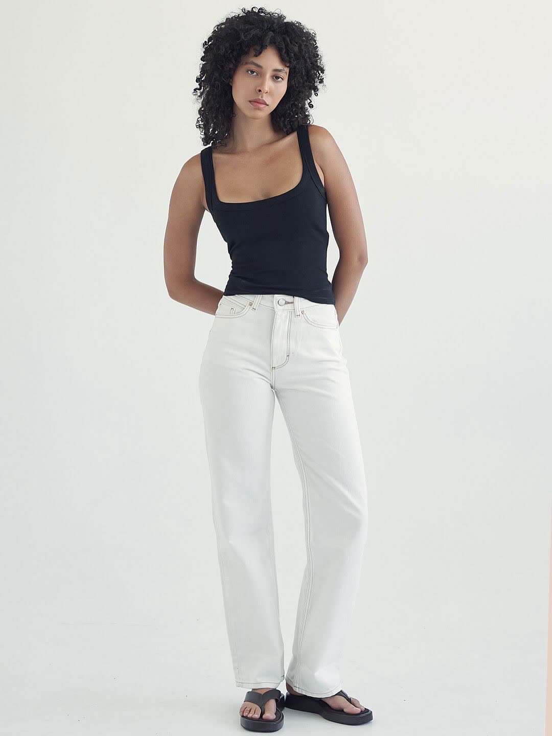 Test frame: full length in a black tank, white jeans and flat sandals