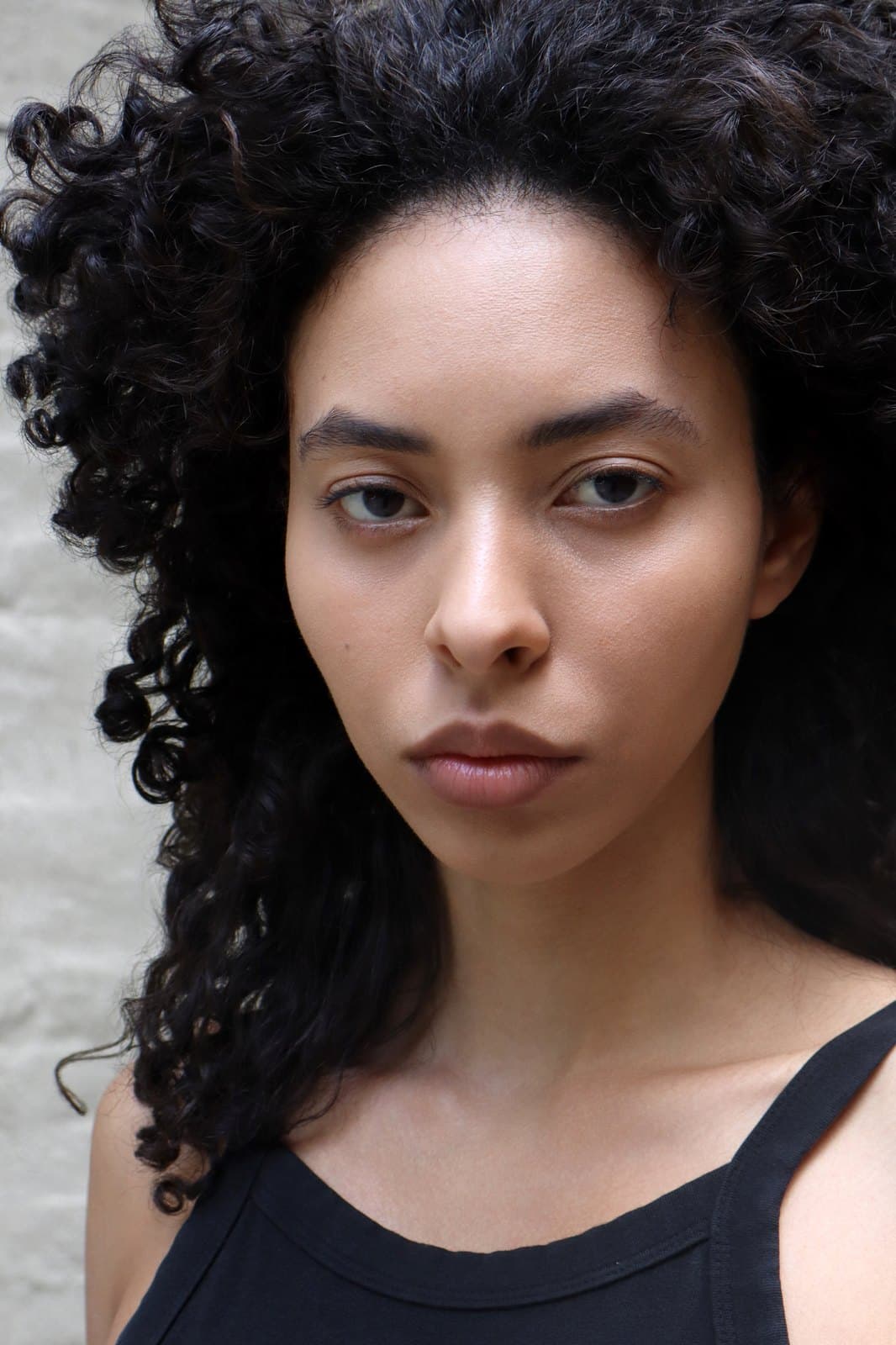 Digital, june 2026: close head shot, curls loose, neutral expression