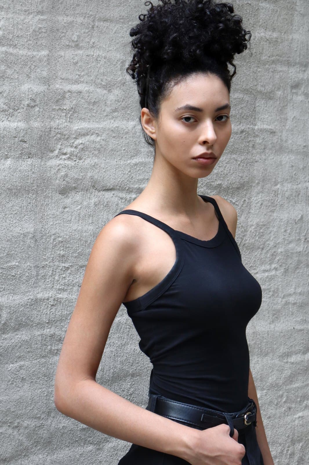 Digital, june 2026: profile in a black tank, hair up