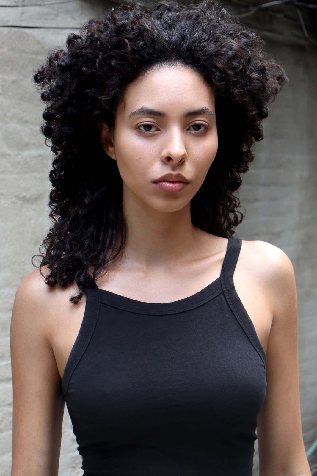 Digital, june 2026: portrait in a black tank, natural curls