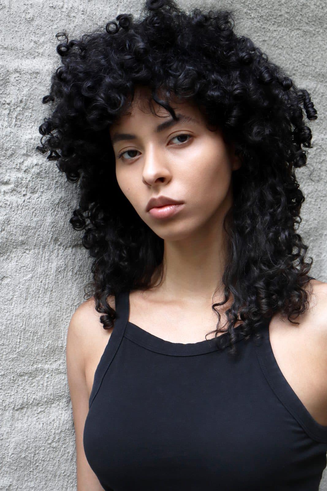Digital: Jess in a black tank, natural curls, facing camera