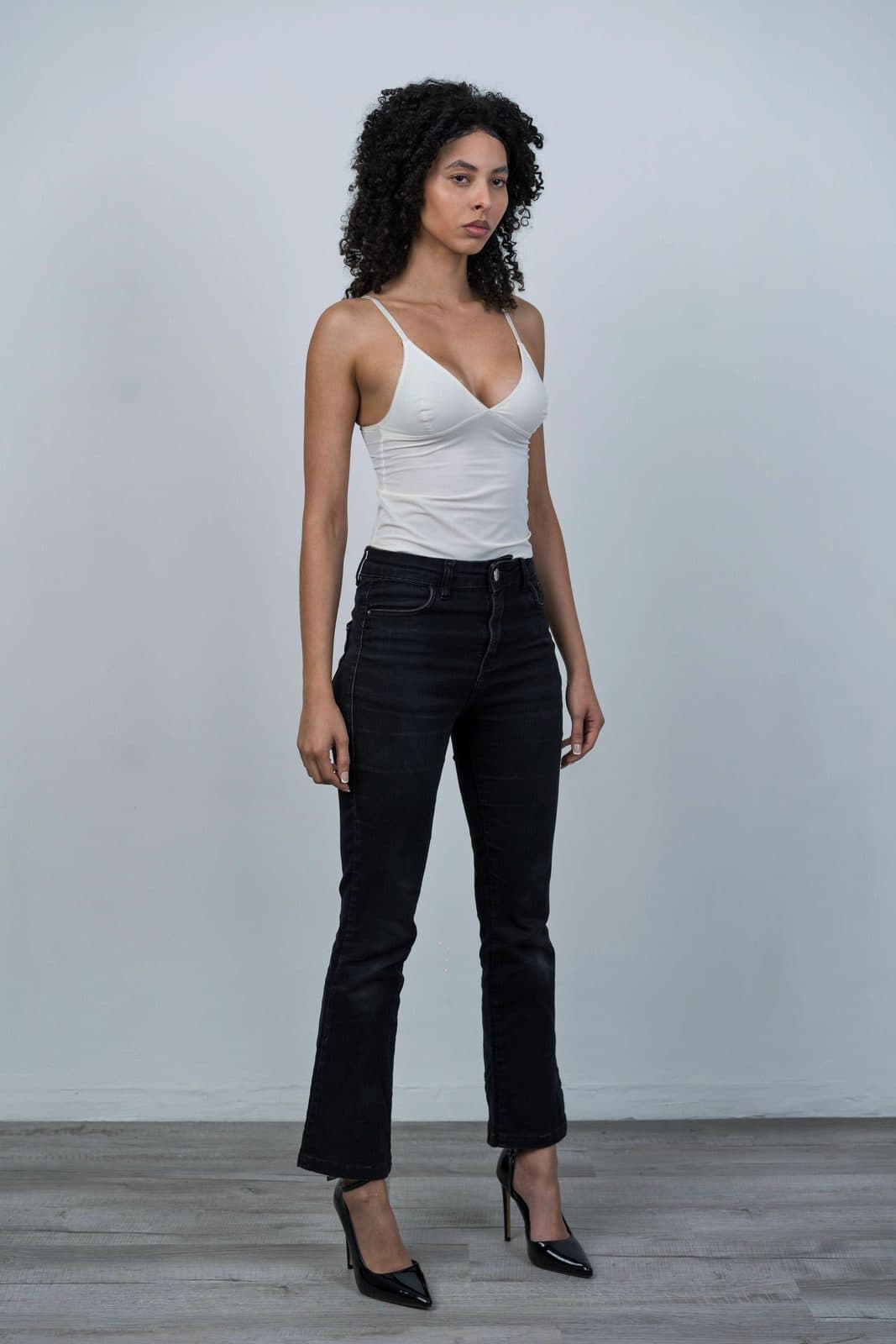 Digital: full length in white top and dark jeans, heels