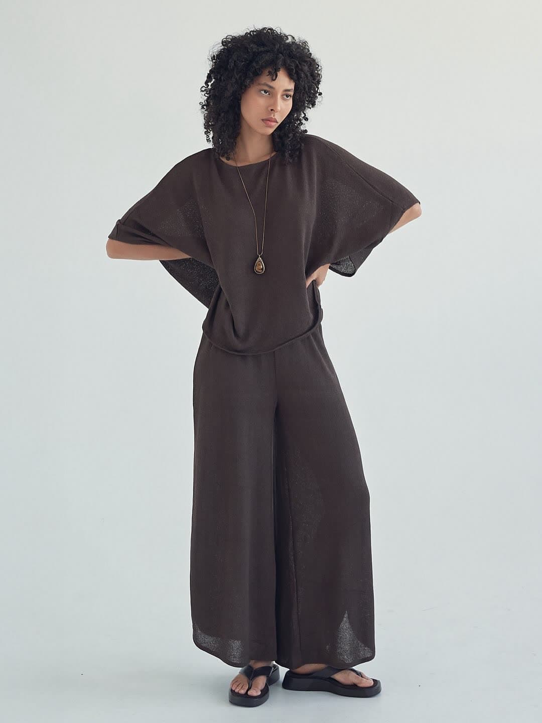 Test frame: full length in the mocha knit set, hands at her hips