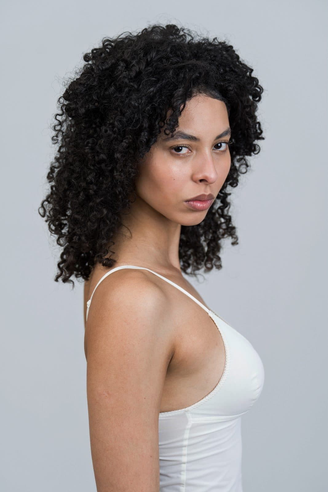 Digital: profile in a white camisole, curls loose